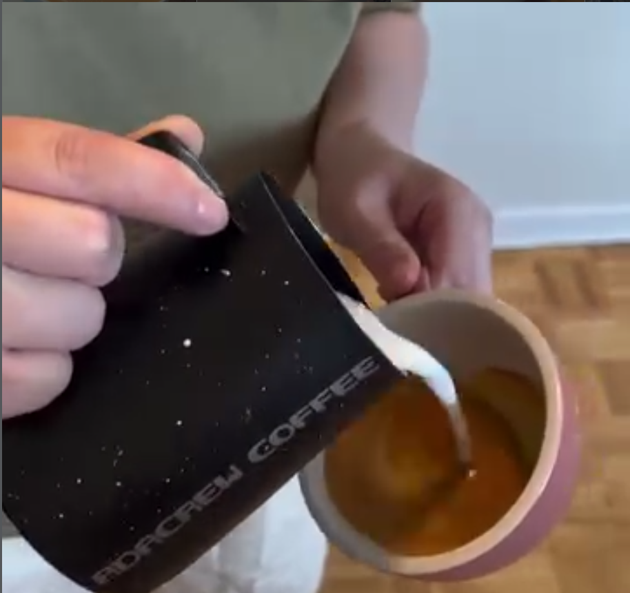 starting from high, about 10cm from cup surface, mix the milk with espresso